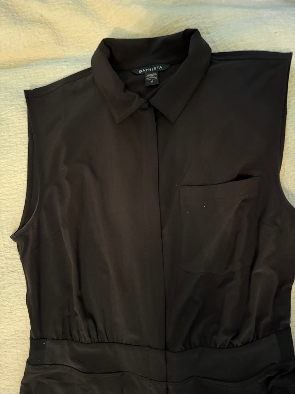 Athleta Black Sleeveless Collared Zip up Jumpsuit with zip side pockets.